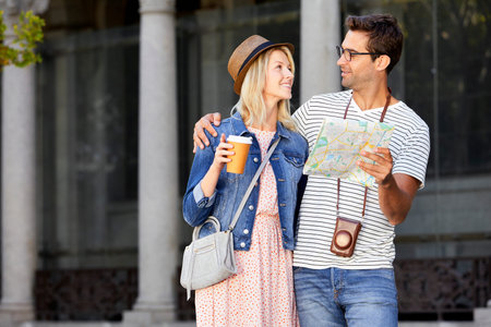 Couple on city break with map, smilingの写真素材