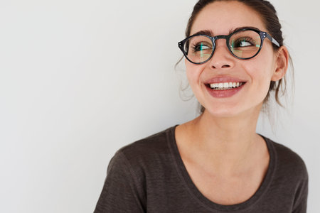 Girl in glasses looking away, smiling