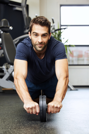 Exercise guy in gym looking at cameraの写真素材
