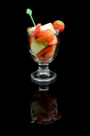 Fruit cocktail with strwaberry and melon on black backgroundの写真素材