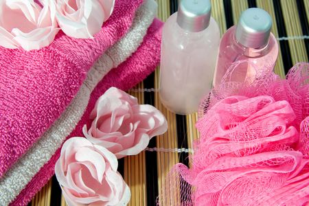 Pink colored bath accessory on cane matの写真素材