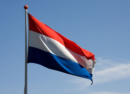 Fluttering dutch flag against blue sky
