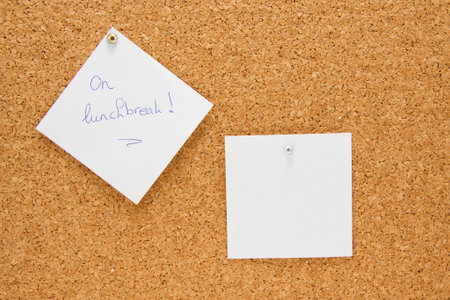 memo board with message on lunchbreak and one empty