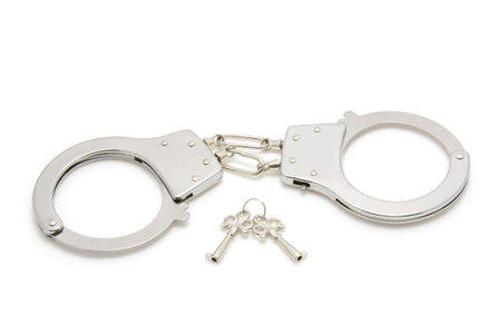 closed silver handcuffs isolated on white background