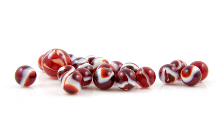 beautiful red colored shoot marbles isolated on white backgroundの写真素材