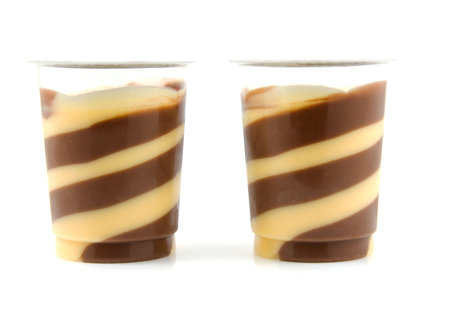 Two delicious chocolate with vanilla dessert isolated on white backgroundの写真素材
