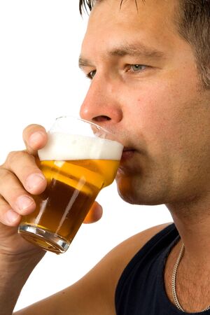 Man is drinking cold beer in closeup, isolated on white backgroundの写真素材