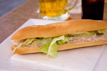 delicious baguette with tuna salad on white plateの写真素材