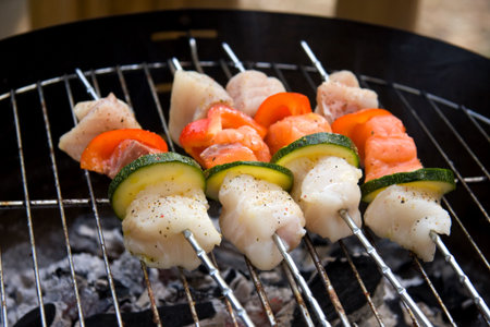 delicious fish spear grilling on barbecueの写真素材