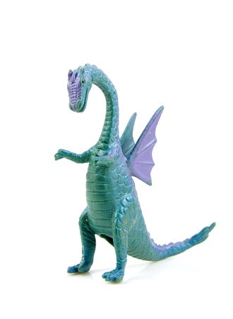 purple green plastic dragon toy isolated on white backgroundの写真素材