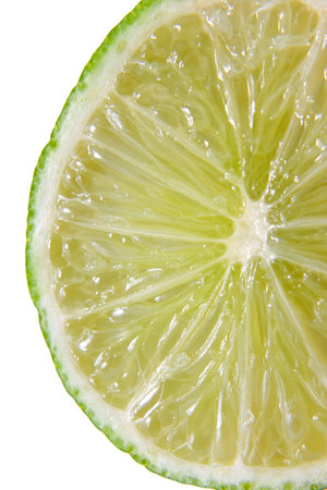 Fresh juicy lime in closeup over white background