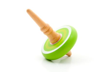 One green spinning top toy isolated on white backgroundの写真素材