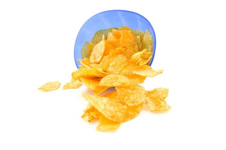 potato chips falling out of blue plastic bowl, isolated on white backgroundの写真素材