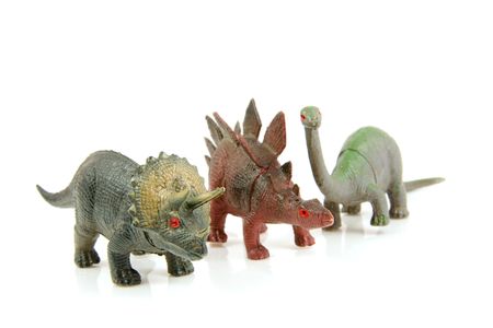 couple of plastic dinosaur toys isolated on white backgroundの写真素材