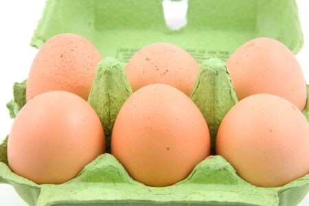 Six chicken eggs in green carton boxの写真素材