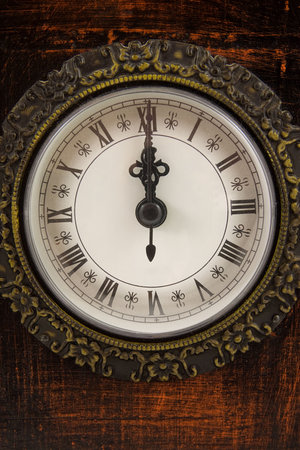 Big clock strikes twelve o'clock in closeup