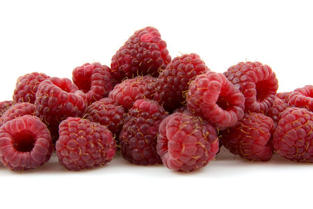 closeup of fresh raspberries over white background