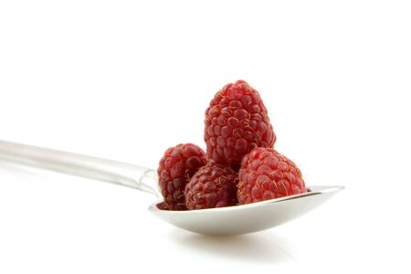 Fresh raspberrie on spoon in closeup isolated on white backgroundの写真素材