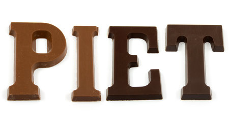 The word "PIET" in chocolate letters isolated on white background, typical Dutch candy for Sinterklaas event in decemberの写真素材
