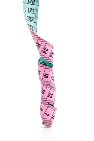 pink and green measure tape over white backgroundの写真素材