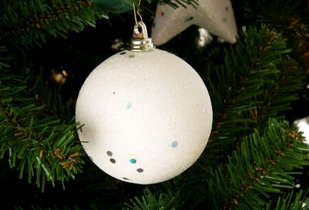 White christmas ball in closeup in treeの写真素材