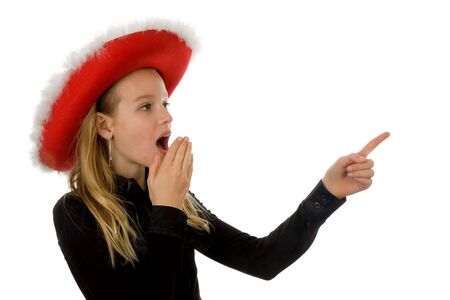 Girl with christmas hat looks amazed over white backgroundの写真素材
