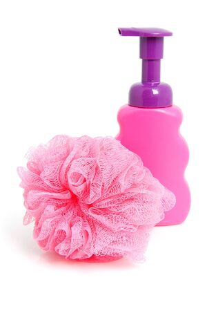 Pink soap bottle with sponge over white backgroundの写真素材