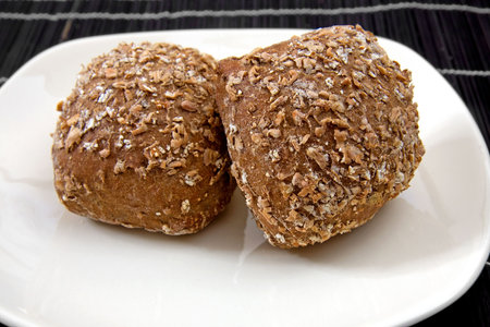 Two healthy home baked buns on white plate ready to eat