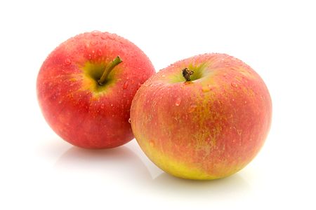 Two juicy apples with water drops over white backgroundの写真素材