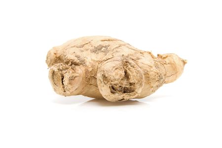 Piece of fresh ginger isolated on white backgroundの写真素材