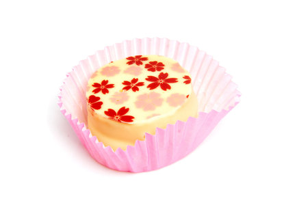 Delicious petit four, little cake over white background