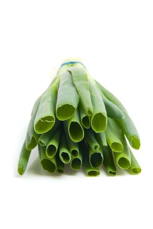 Front view of a pile spring onions isolated on white backgroundの写真素材