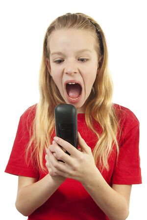 Girl is angry on the phone over white backgroundの写真素材