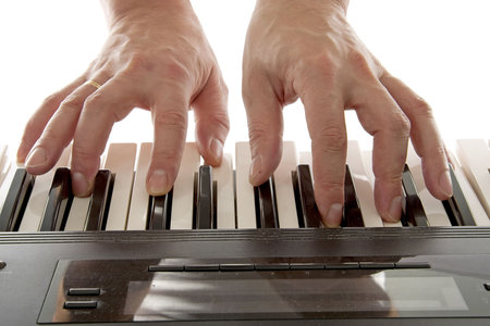Hands are playing the piano over white background