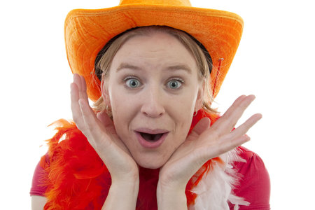 portrait of Dutch soccer fan in orange outfit who looks surprised over white backgroundの写真素材