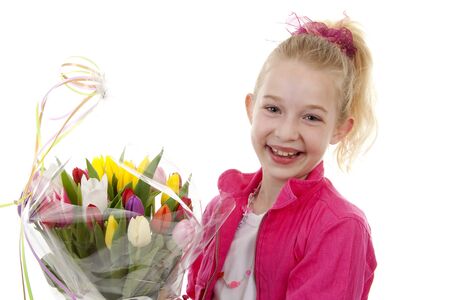 young blonde girl with bouquet of colorful Dutch tulips for mothers day over white background looking into cameraの写真素材