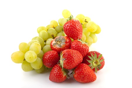 Fresh fruits: strawberries and grapes over white backgroundの写真素材