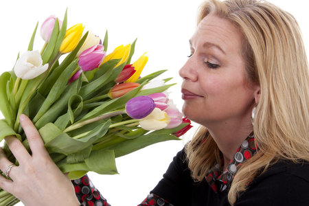 Woman with Dutch tulip flowers over white backgroundの写真素材