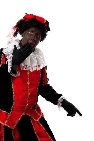 surprised Zwarte piet ( black pete) typical Dutch character part of a traditional event celebrating the birthday of  Sinterklaas in december over white background is pointingの写真素材