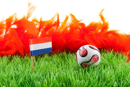 ball and Dutch flag on soccer field over white backgroundの写真素材