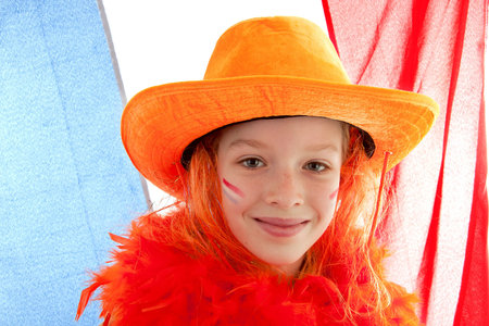 Young Dutch soccer supporter in orange outfit against the Netherlands flagの写真素材
