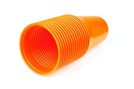 Stack of orange plastic cups isolated on white backgroundの写真素材