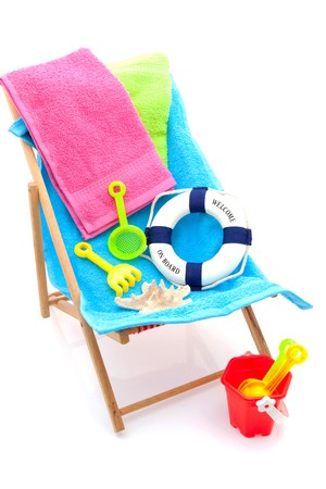 beach chair with colorful towels and toys over white backgroundの写真素材