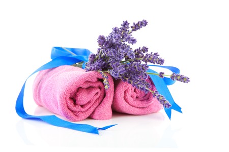 spa accessories with lavender and pink towels over white backgroundの写真素材