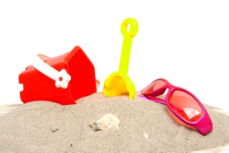 pink sunglasses and beach toys over white backgroundの写真素材