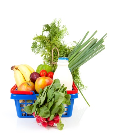 Shopping basket filled with healthy grocery over white backgroundの写真素材
