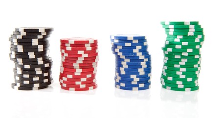 stacks of colorful poker casino chips over white backgroundの写真素材