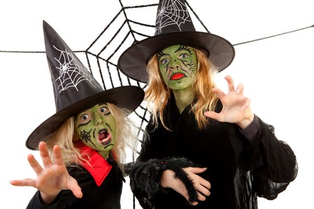 Scary green witches for Halloween with spiderweb over white backgroundの写真素材
