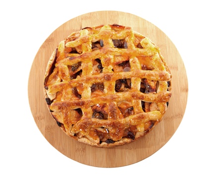 Delicious home baked apple pie on wooden cutting board isolated on white background 
の写真素材