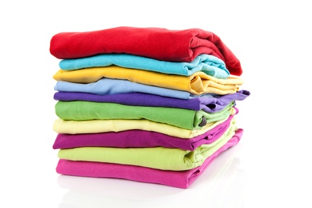 Pile of colorful clothes over white backgroundの写真素材